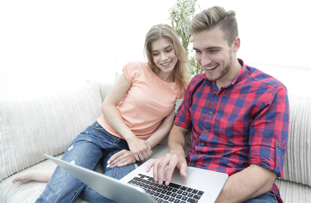 Heureux couple moderne surfer sur le net et de travailler sur ordinateur portable à la maison - Photo, image