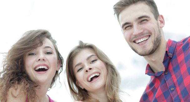 closeup of three young people smiling on white background - Foto, immagini