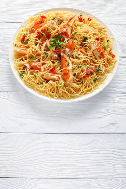 spaghetti with cracked Crab legs, top view - Foto, imagen