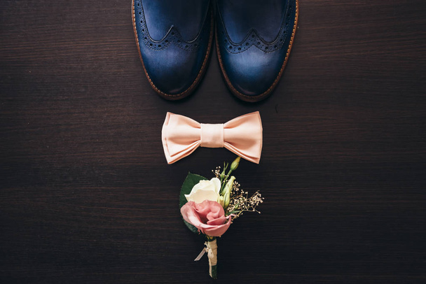 Stylish men's shoes on a dark wooden table - Фото, изображение