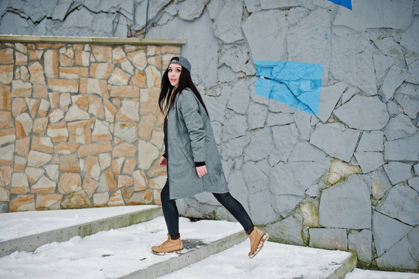 Stylish brunette girl in gray cap, casual street style on winter - Fotó, kép
