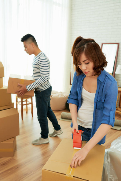 asian Couple packing their stuff in carton boxes - Photo, Image