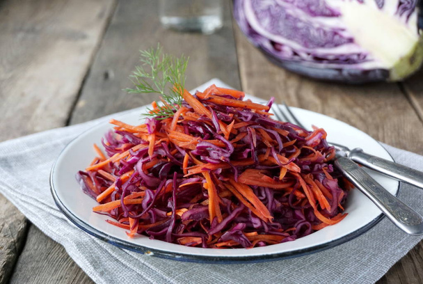 Salad with red cabbage and carrots in a plate - Photo, Image