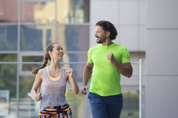 Couple running in urban enviroment - Photo, Image