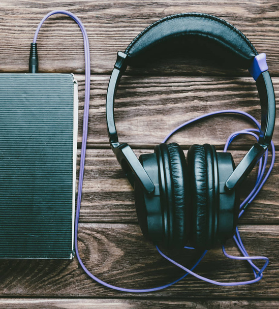 Headphones with a paper book. - Foto, Imagem