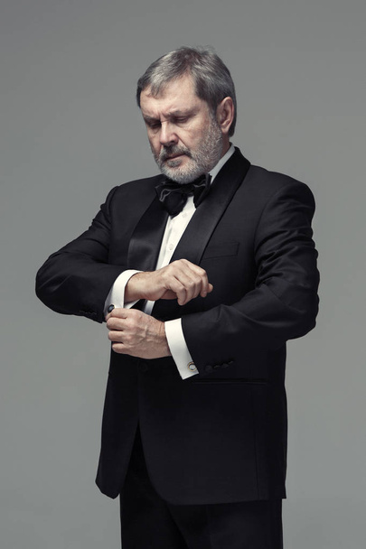 Middle aged male adult wearing a suit isolated on gray - Foto, Bild