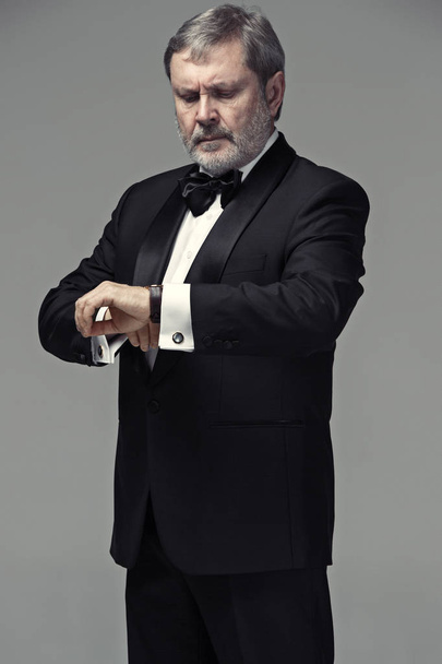 Middle aged male adult wearing a suit isolated on gray - Fotografie, Obrázek