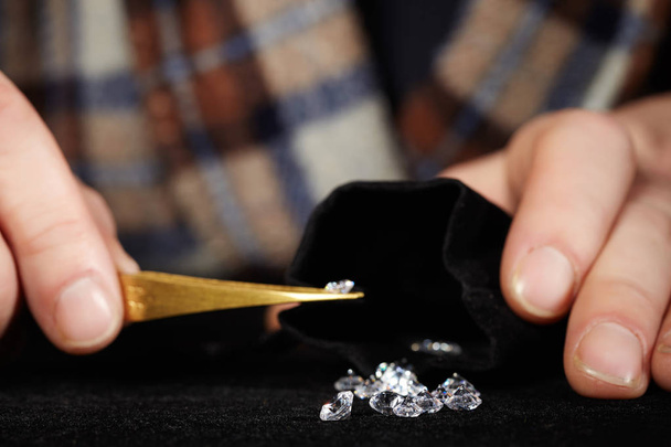 Delivery of brilliant diamonds ready for smuggling in black velvet bag - Photo, Image