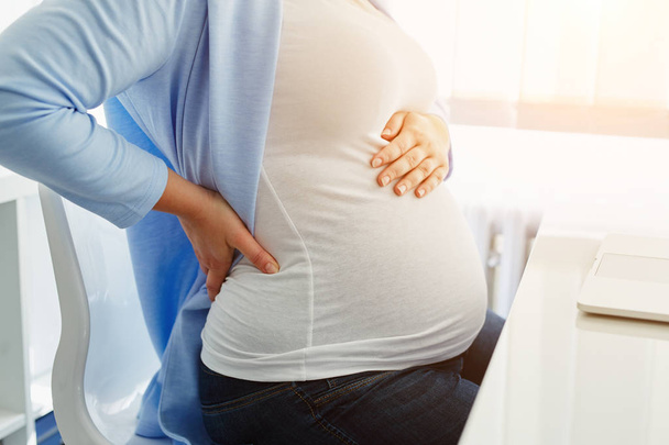 Pregnant woman with back pain - Valokuva, kuva