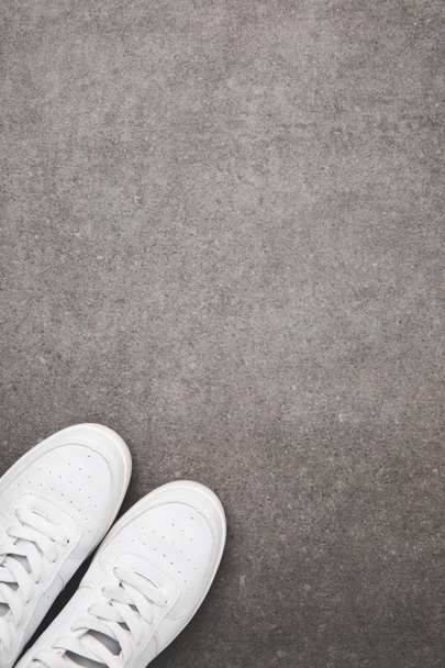 top view of stylish white shoes on concrete surface - Photo, Image
