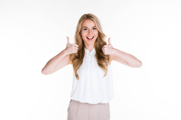 Perfect deal! Beautiful young woman looking at camera with smile and gesturing fist up while standing against white background - Photo, Image