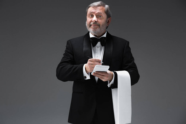 Waiter taking an order wearing a waistcoat in a fancy restaurant - Foto, afbeelding