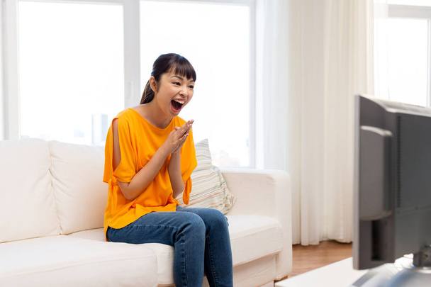 happy asian woman with watching tv at home - Фото, зображення