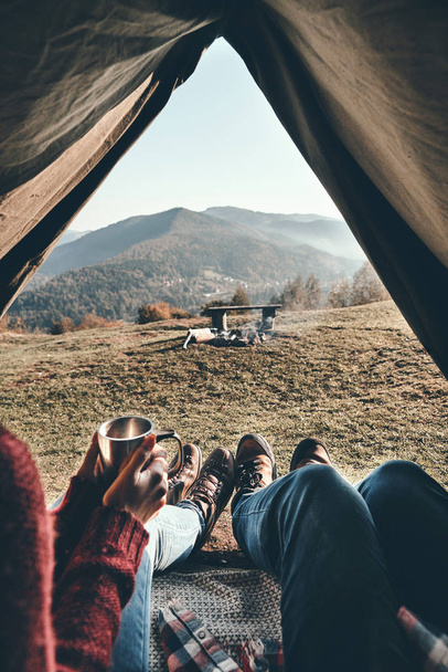 partial view, close up of couple enjoying view of mountain range while lying in tent - Fotó, kép