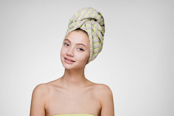 happy woman with a towel on her head after a shower - Zdjęcie, obraz