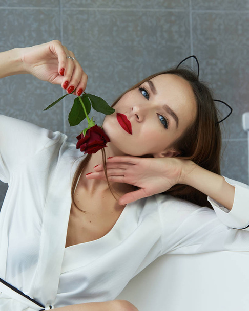Sexy woman in bathroom in silk robe rose Valentine's day - Valokuva, kuva