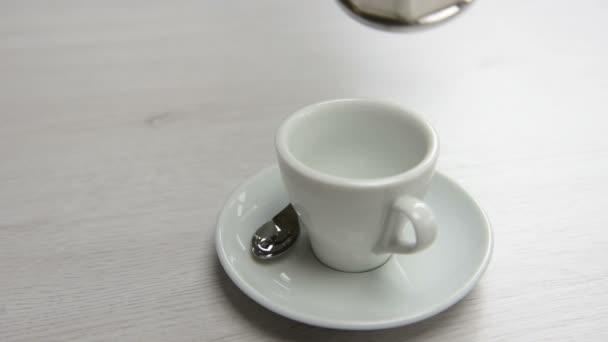 cafeteira derramando café preto na xícara na mesa. Tiro com movimento circular
. - Filmagem, Vídeo