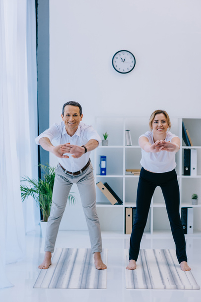 happy mature businessman with his trainer warming up before yoga practice - Fotoğraf, Görsel