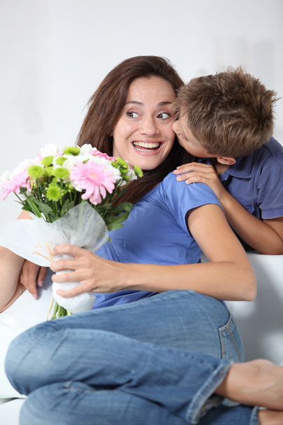 Little boy kissing his mom on mother's day - Photo, image