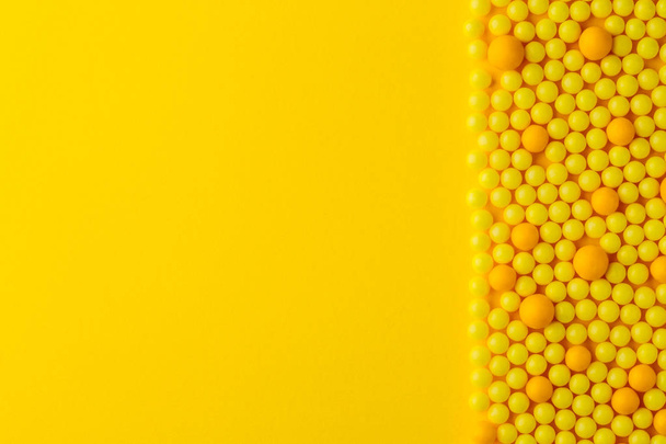 Yellow round pills  on yellow  background, free space for text.  Medicine and pharmacy concept. - 写真・画像