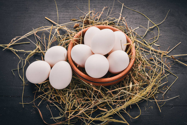 Chicken raw white eggs. On a wooden background. Top view. Copy space. - Foto, imagen