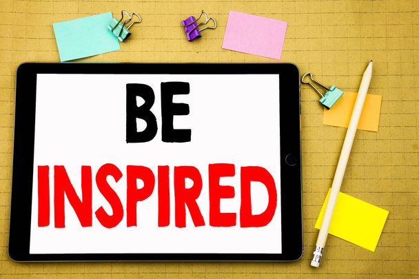 Hand writing text caption inspiration showing Be Inspired. Business concept for Inspiration and Motivation Written on tablet laptop, wooden background with sticky note and pen - Photo, Image