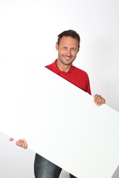 Man in red shirt showing white board - Valokuva, kuva