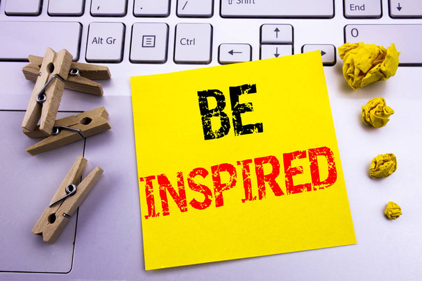 Hand writing text caption inspiration showing Be Inspired. Business concept for Inspiration and Motivation written on sticky note paper on the white keyboard background. - Fotó, kép