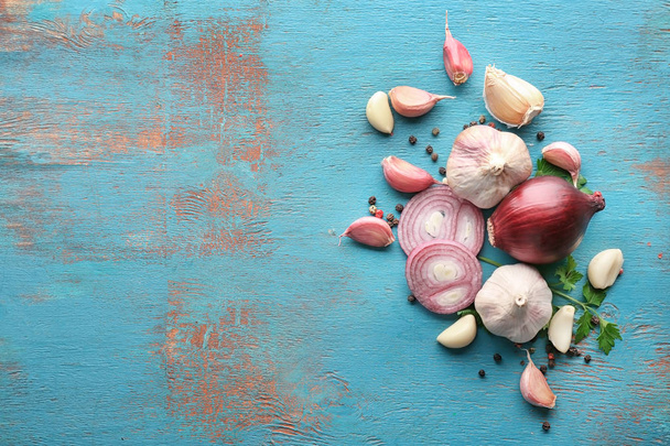 Fresh garlic and onion on color background, top view - 写真・画像