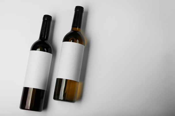 Wine bottles with blank labels on light background. Mock up for design - Foto, imagen