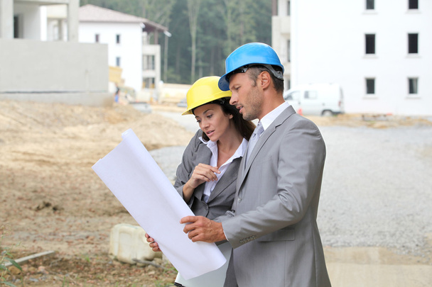 Team of architects checking plans on site - Photo, Image