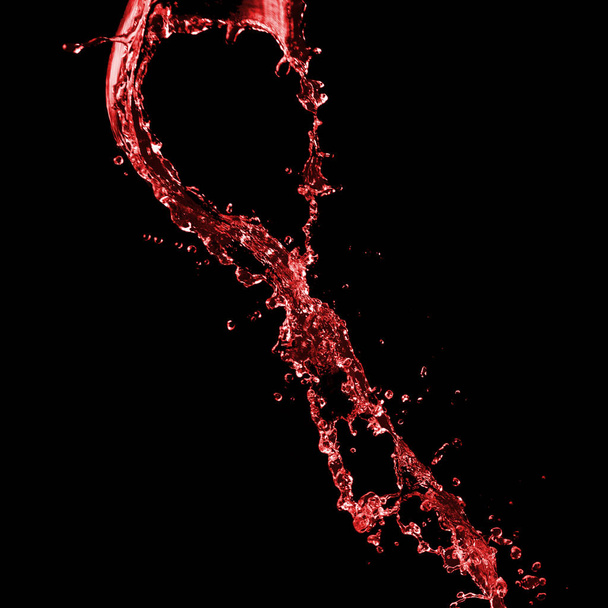 Red splash on a black - Foto, imagen
