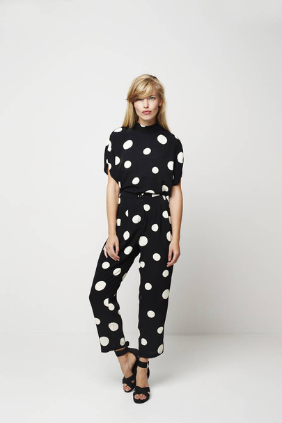 Beautiful young woman posing in spotted jumpsuit, portrait - Photo, image