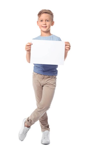 Cute boy with blank sheet of paper for advertising on white background - Zdjęcie, obraz