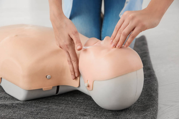 Woman practicing first aid on mannequin, closeup - Foto, immagini