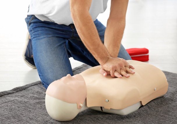 Man practicing first aid on mannequin, closeup - Foto, Imagen