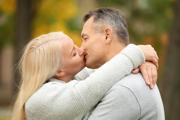 Feliz pareja madura besándose al aire libre
 - Foto, Imagen