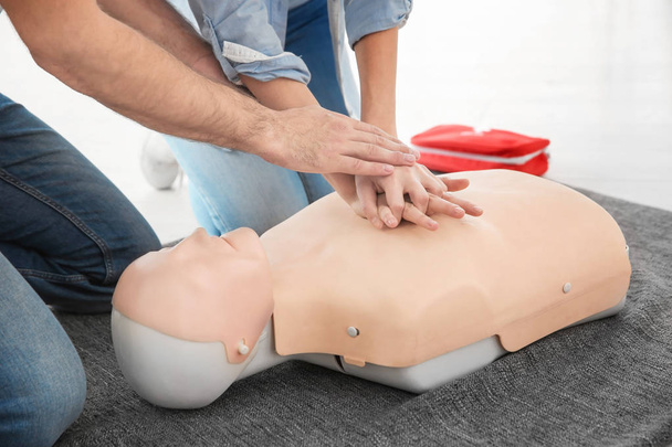 Woman practicing CPR on mannequin in first aid class, closeup - Photo, Image