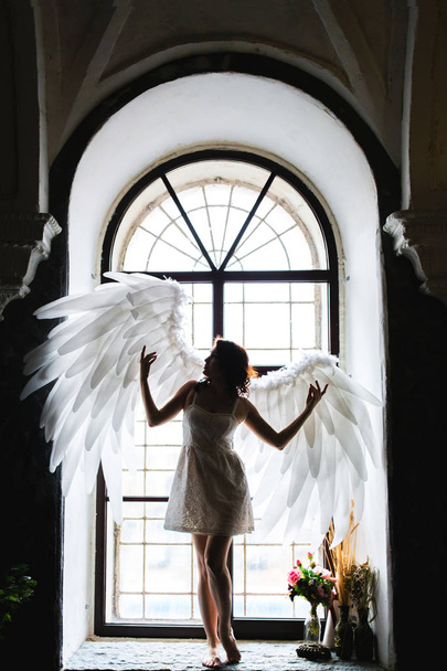 Young woman in angel costume - Φωτογραφία, εικόνα