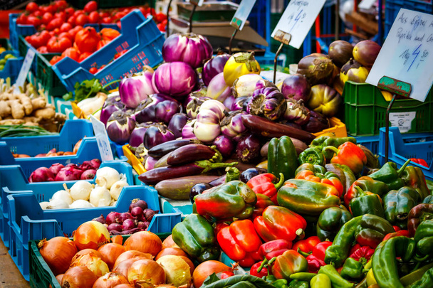 Onions and peppers in the display of a market stall - Photo, Image