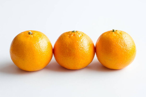 Mandarin isolated on white background. Three ripe tangerines lying around. - Fotoğraf, Görsel