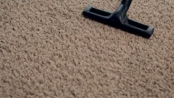 The old woman vacuums the living room, does the cleaning at home - Footage, Video