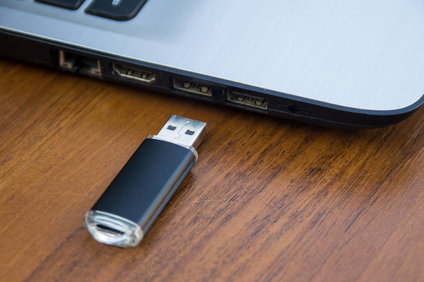 USB memory stick ou flash drive e computador portátil
  - Foto, Imagem