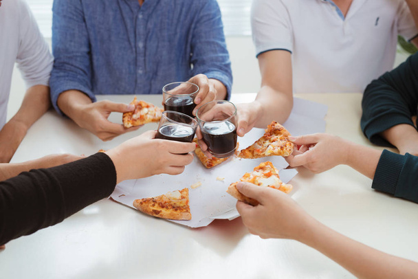 People eat fast food. Friends hands taking slices of pizza  - 写真・画像