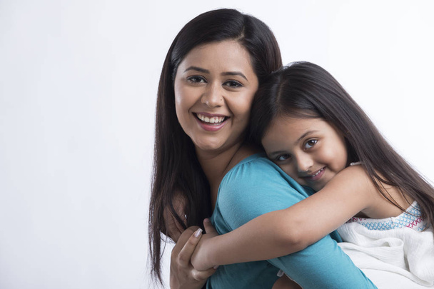 Portret van moeder met dochter op rug - Foto, afbeelding