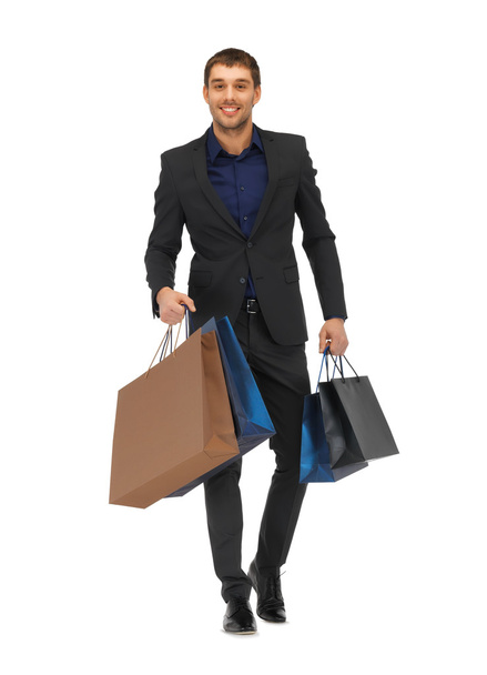 Handsome man in suit with shopping bags - Фото, зображення