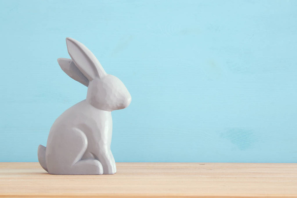 Cute wooden bunny over colorful background. - Foto, Imagem