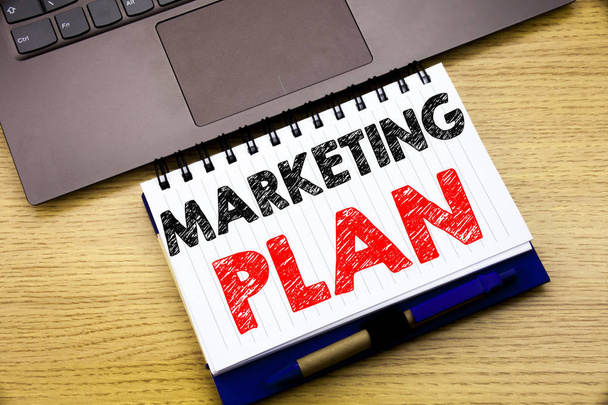 Hand writing text caption inspiration showing Marketing Plan. Business concept for Planning Successful Strategy written on notebook book on the wooden background in the Office with laptop - Photo, Image