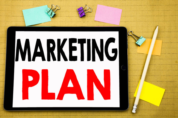 Hand writing text caption inspiration showing Marketing Plan. Business concept for Planning Successful Strategy Written on tablet laptop, wooden background with sticky note and pen - Foto, immagini
