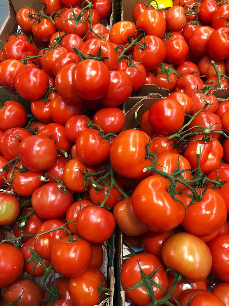 Fresh ripe tomatoes in a box on the market  - Photo, Image